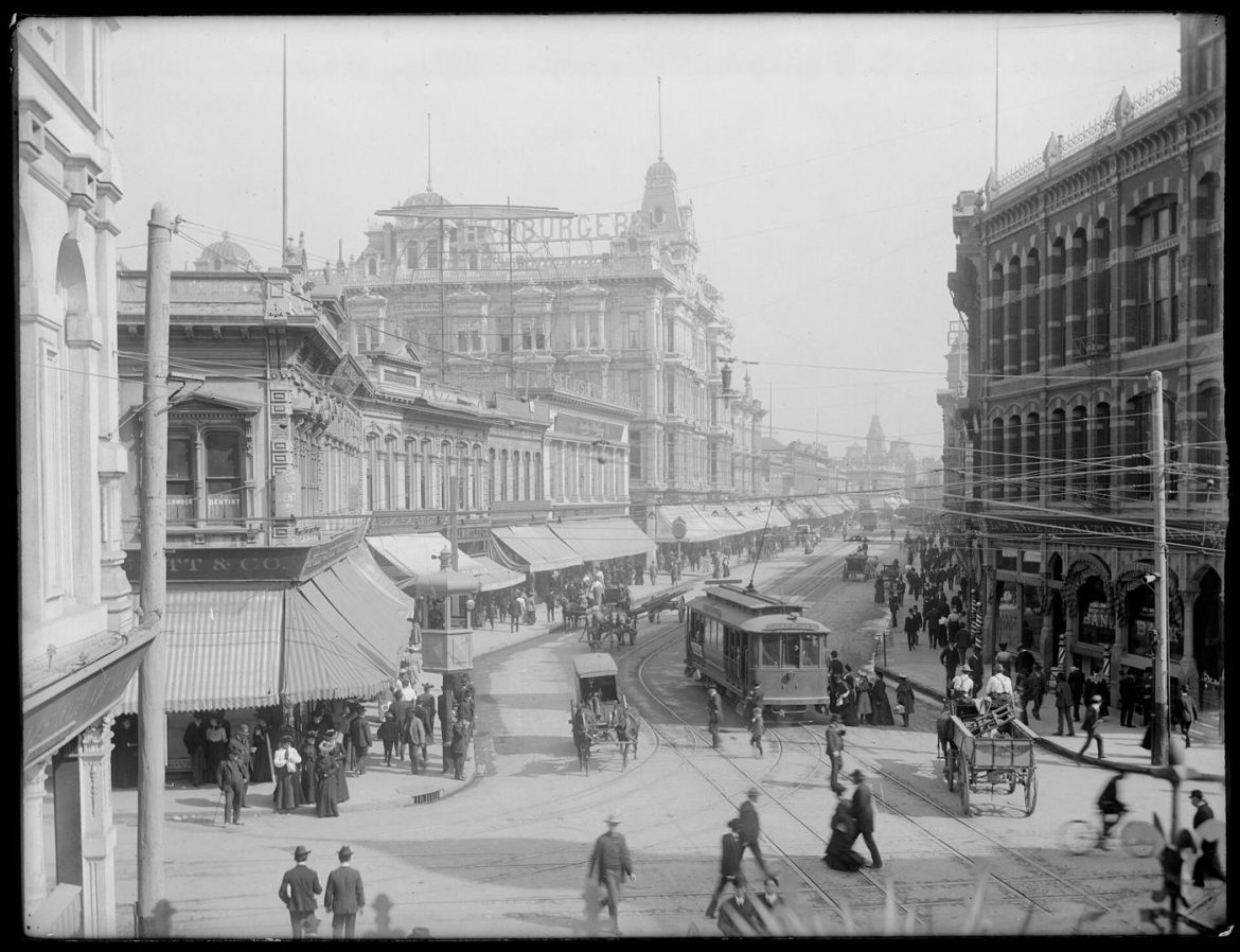 shoppers walking along a busy retail street
